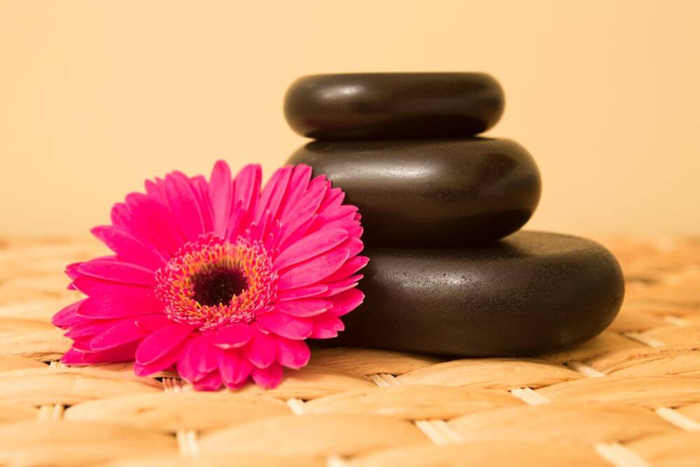picture of flowers and hot stones for massage